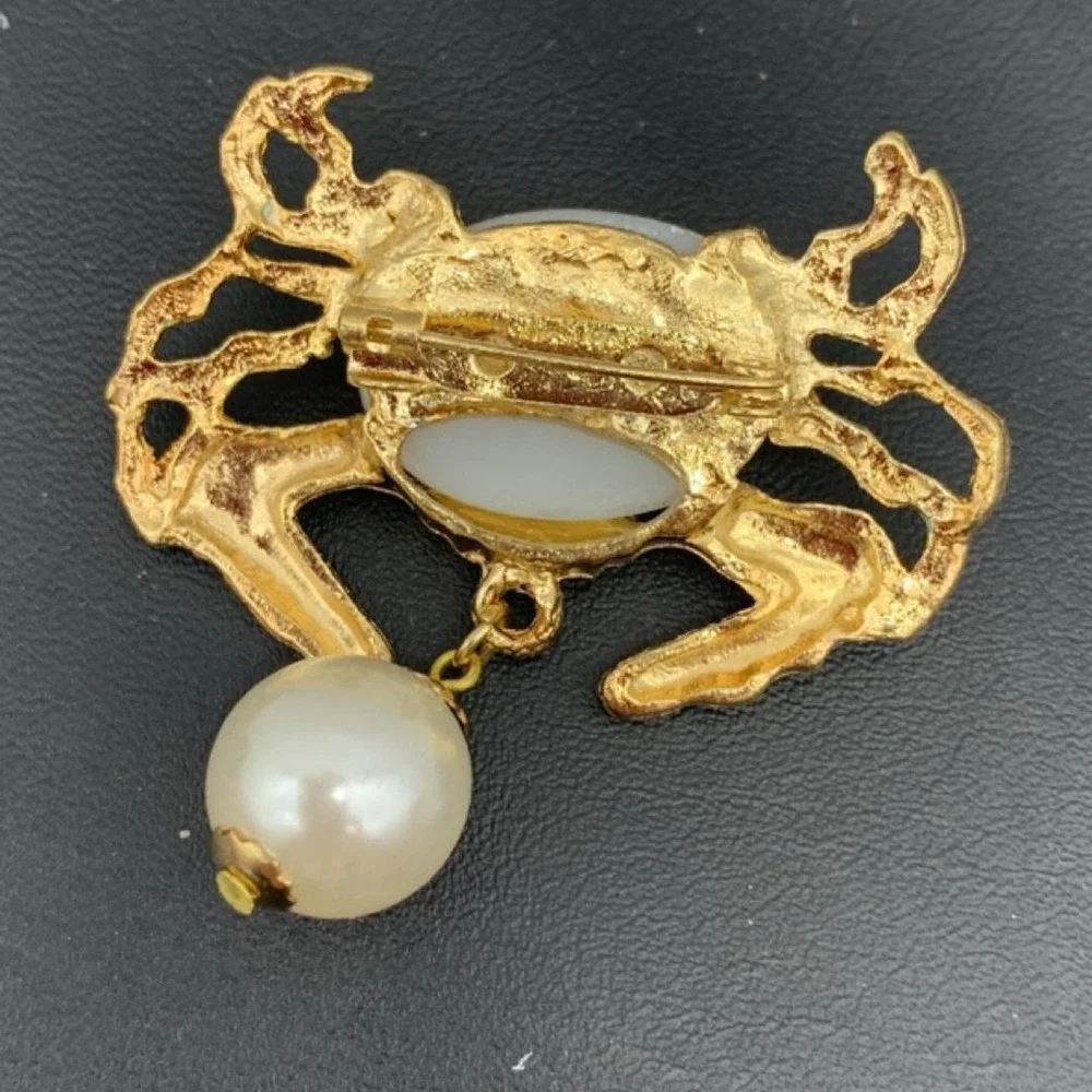 Gold tone crab brooch with faux pearl